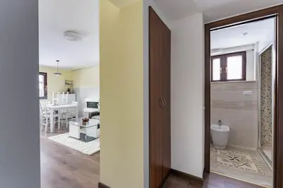 a bathroom with a shower and a toilet in a room at Cortina Comfort House in Cojana