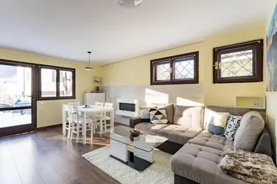 a living room with a couch and a table at Cortina Comfort House in Cojana
