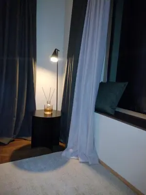 a room with a window with a table and a lamp at Chalet La Ciaseta in Pozza di Fassa