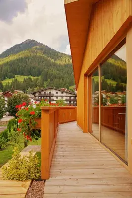 a wooden balcony with a view of a mountain at Chalet La Ciaseta in Pozza di Fassa