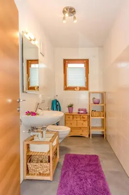 a bathroom with a sink and a toilet and a mirror at Lampenhof in Brunico