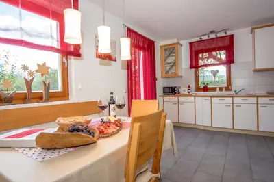 a kitchen with a table with a plate of food on it at Lampenhof in Brunico