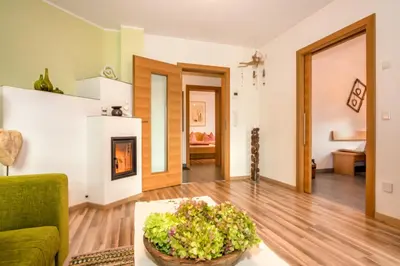 a living room with a green couch and a table at Lampenhof in Brunico