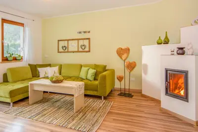 a living room with a couch and a fireplace at Lampenhof in Brunico