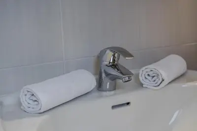 a white bathroom with a shower and a sink at Affittacamere Blank in Arabba