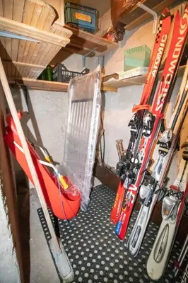 a room with skis and a chair in a cave at A un passo dagli impianti - Penia di Canazei in Penia