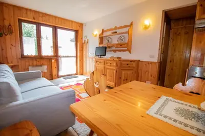 a living room with a couch and a table at A un passo dagli impianti - Penia di Canazei in Penia