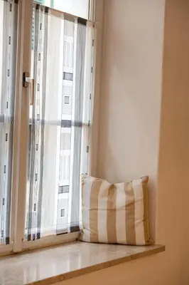 a pillow sitting in front of a window at Suite - Sweet MayLeen in Merano