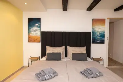 a bedroom with a large bed with two pillows on it at Suite - Sweet MayLeen in Merano