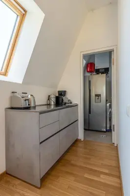 a kitchen with stainless steel cabinets and a refrigerator at Villa Stubai - Penthouse in the heart of Merano in Merano