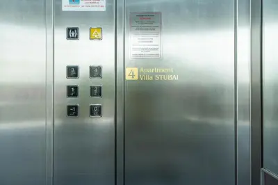 an elevator in an airport with a sign on it at Villa Stubai - Penthouse in the heart of Merano in Merano