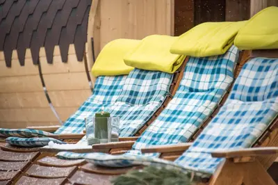 a group of deck chairs sitting on a patio at MOUNTAIN RESIDENCE ALPENHOF - company Hotel Alpenhof KG sas der Gasser Renate in Bressanone