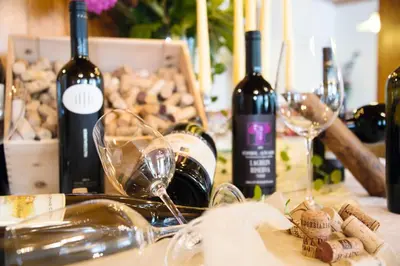 a table topped with bottles of wine and wine glasses at MOUNTAIN RESIDENCE ALPENHOF - company Hotel Alpenhof KG sas der Gasser Renate in Bressanone