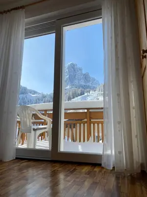 a large window with a view of a snowy mountain at Amalia Apartment in Santa Cristina in Val Gardena