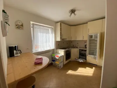 a kitchen with a table and a counter top at Amalia Apartment in Santa Cristina in Val Gardena