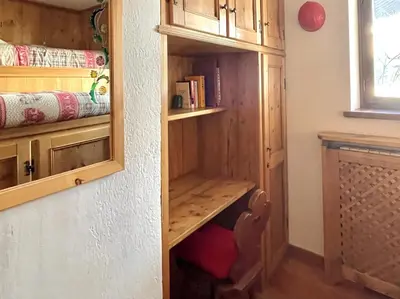 a room with a closet with a book shelf at El Fogher in San Vito di Cadore