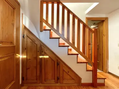 a wooden staircase in a home with wooden cabinets at El Fogher in San Vito di Cadore