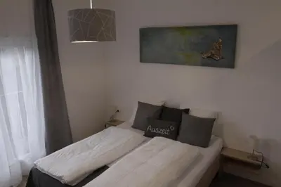 a bed in a bedroom with a painting on the wall at Apartment Mia in Merano