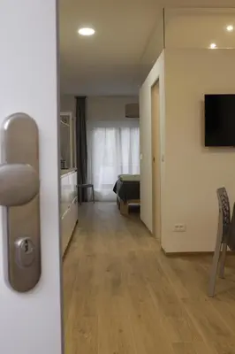 a room with a hallway with a bed and a television at Apartment Mia in Merano