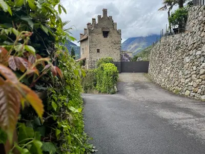 an empty road with a stone building in the background at Apartment Mia in Merano