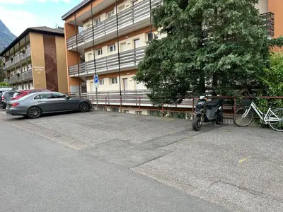 a scooter parked in a parking lot next to a building at Apartment Mia in Merano