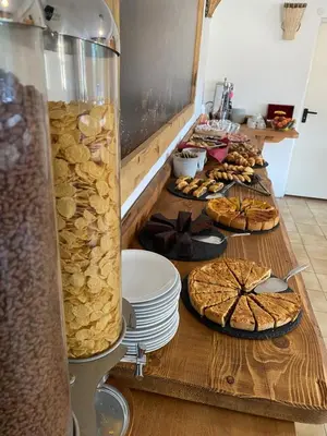 a table topped with plates of bread and pies at Hotel Oasi in San Vito di Cadore
