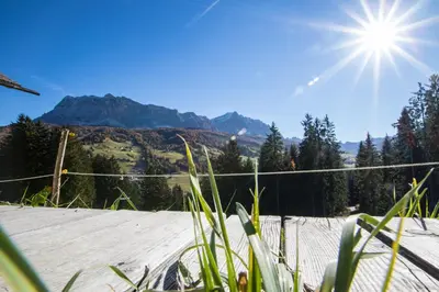 a view of a tennis court with mountains in the background at Agriturismo Maso Runch in Badia