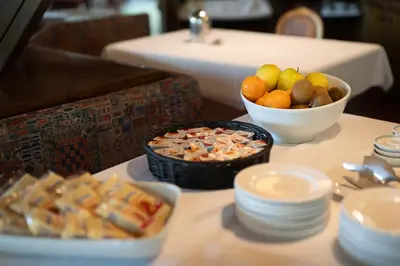 a table with a bowl of fruit and a bowl of food at Hotel Sporting in Val di Zoldo