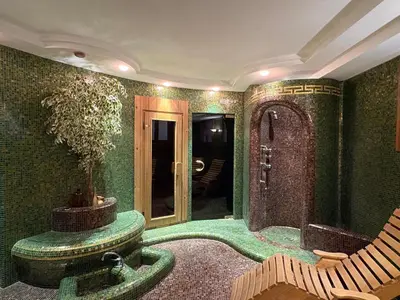 a green room with a fountain and a chair in it at Hotel Sporting in Val di Zoldo
