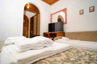 a bedroom with a bed with white towels on it at Hotel Sporting in Val di Zoldo