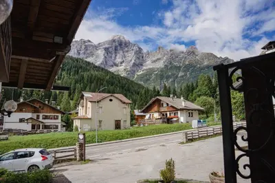a view of a mountain range from a house at Hotel Sporting in Val di Zoldo