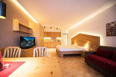 a living room with a couch and a table in a room at Apartment Lilli mit Garagenstellplatz in Bressanone