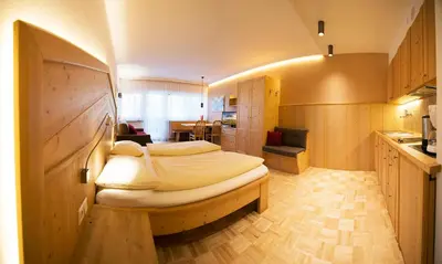 a bedroom with a large bed in a room at Apartment Lilli mit Garagenstellplatz in Bressanone
