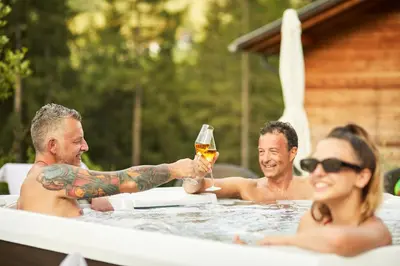 a group of people in a bathtub with a woman holding a beer at Chalet Mi Amur in La Villa
