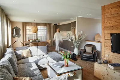 a man is standing in a living room at Chalet Mi Amur in La Villa