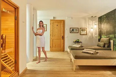 a woman standing in a room with two beds at Chalet Mi Amur in La Villa