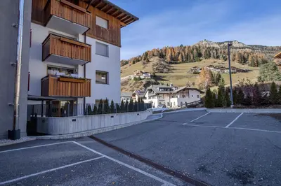an empty parking lot in front of a building at Apartment Lulu in Selva di Val Gardena