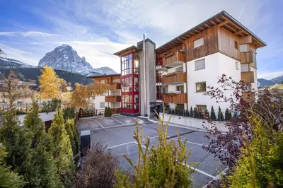 a view of a building with a mountain in the background at Apartment Lulu in Selva di Val Gardena