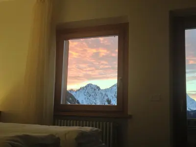 a window with a view of a snowy mountain at Rifugio Capanna Bill in Rocca Pietore