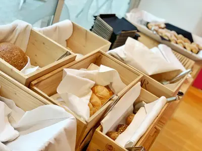 a group of boxes filled with different types of bread at Hotel Aurora in Merano