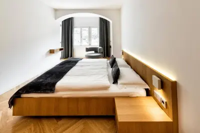 a bedroom with a large bed and a window at Apartment Genziana in Ortisei