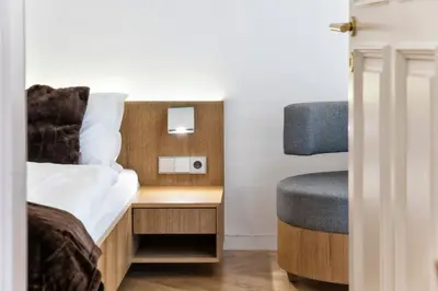 a small room with a bed and a chair at Apartment Genziana in Ortisei