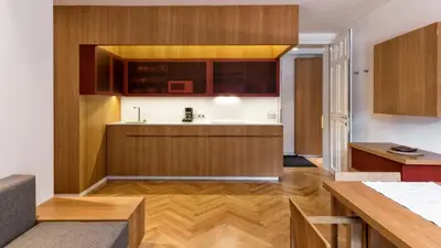 a kitchen with wooden cabinets and a counter top at Apartment Genziana in Ortisei