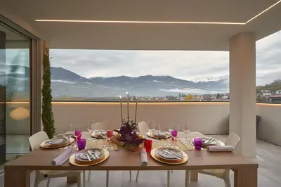 a dining room table with a view of mountains at Penthouse I CIPRESSI in Postal