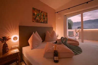a bedroom with two beds and a large window at Penthouse I CIPRESSI in Postal