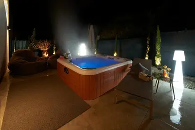 a large hot tub in a living room at night at Penthouse I CIPRESSI in Postal