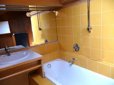 a yellow bathroom with a tub and a sink at ATI Appartamento stile Chalet dell 800 nel cuore di Ortisei in Ortisei