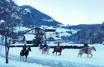 a group of people riding horses in the snow at ATI Appartamento stile Chalet dell 800 nel cuore di Ortisei in Ortisei