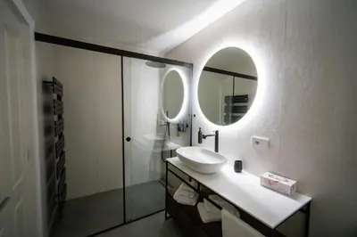 a bathroom with a sink and a mirror at Guesthouse diWINE in Merano