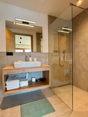 a bathroom with a sink and a shower at Schneiderhof, Chalet, Urlaub auf dem Bauernhof in Ridanna